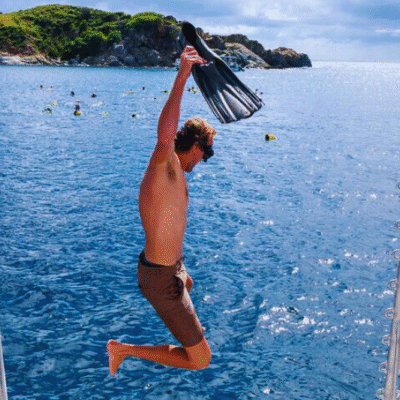 Chukka Private Catamaran Charter Man Jumping in Water