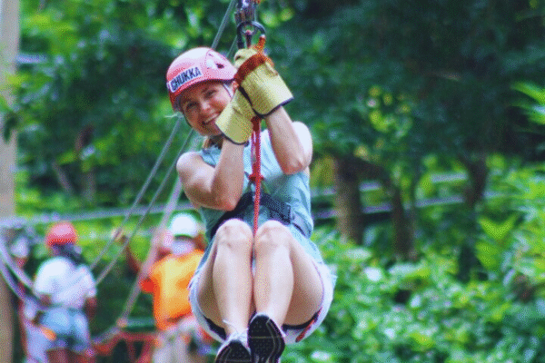 Chukka Zipline and Challenge Course Woman Smiling on Zipline